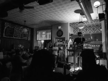 Live music performance in a dimly lit venue.