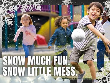 Preschool children playing with fake snowballs under fake snow.