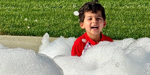 Kids celebrating a birthday in South Carolina with music, foam, and outdoor summer fun