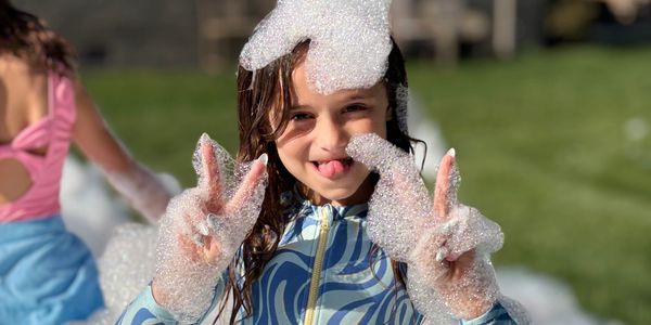 Close-up of kids’ faces covered in foam bubbles during an foam party in Indian Trail  or Weddington 