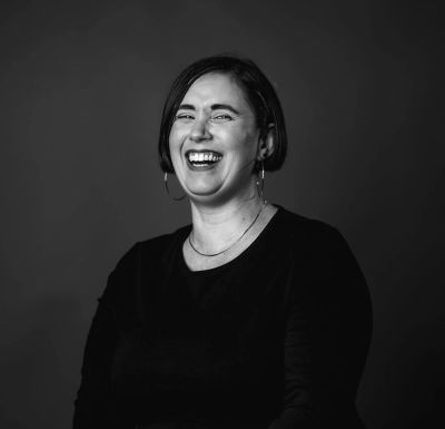 Woman laughing in black and white photo.