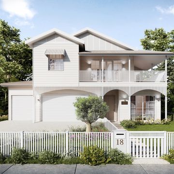 Two-story white house with porch and garden.