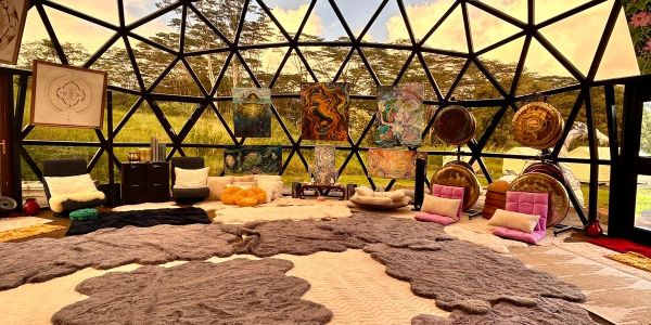 Cozy dome room with art and cushions.