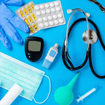 Medical tools including stethoscope and medication on a blue background.