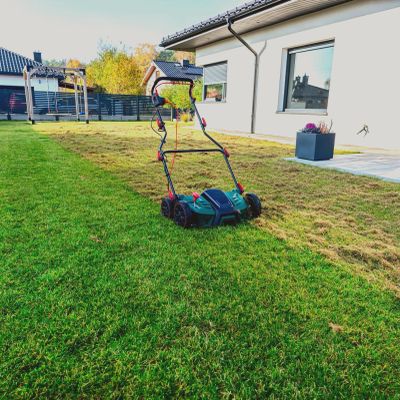 Electric lawn mower on a lawn.