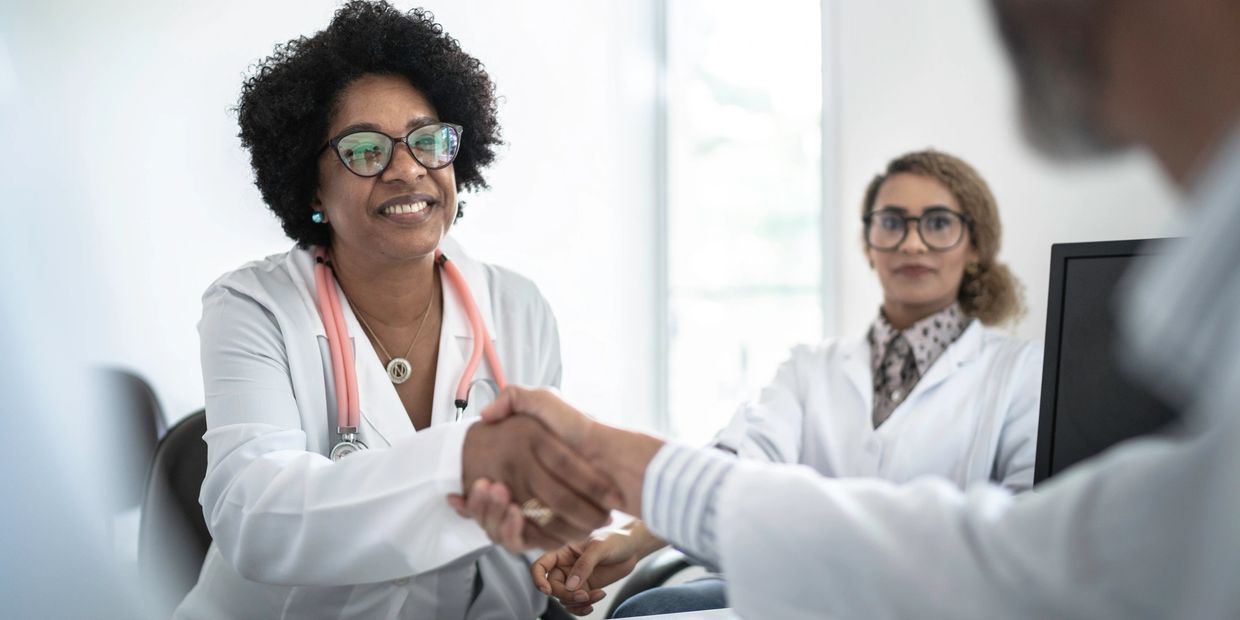 Female physician shaking hands.