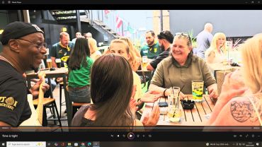 Group of friends enjoying drinks at an outdoor cafe.
