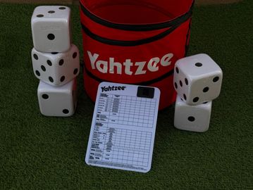 Yahtzee game setup with oversized dice and scorecard.