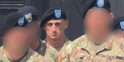 Group of soldiers in uniform with blurred faces.