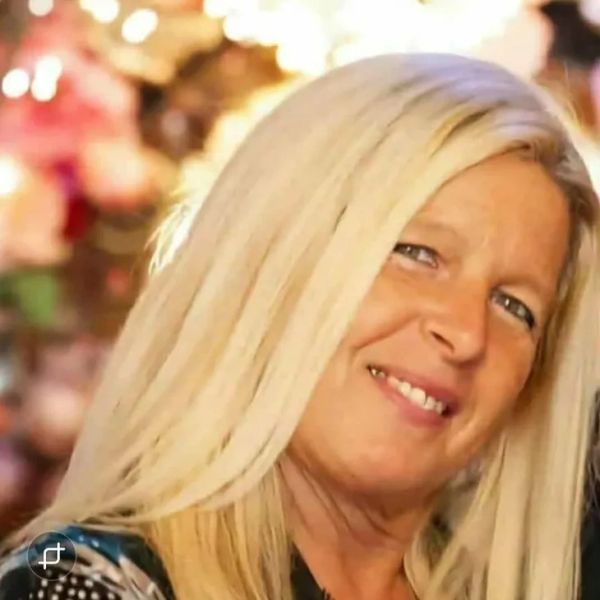 Smiling blonde woman with long hair.