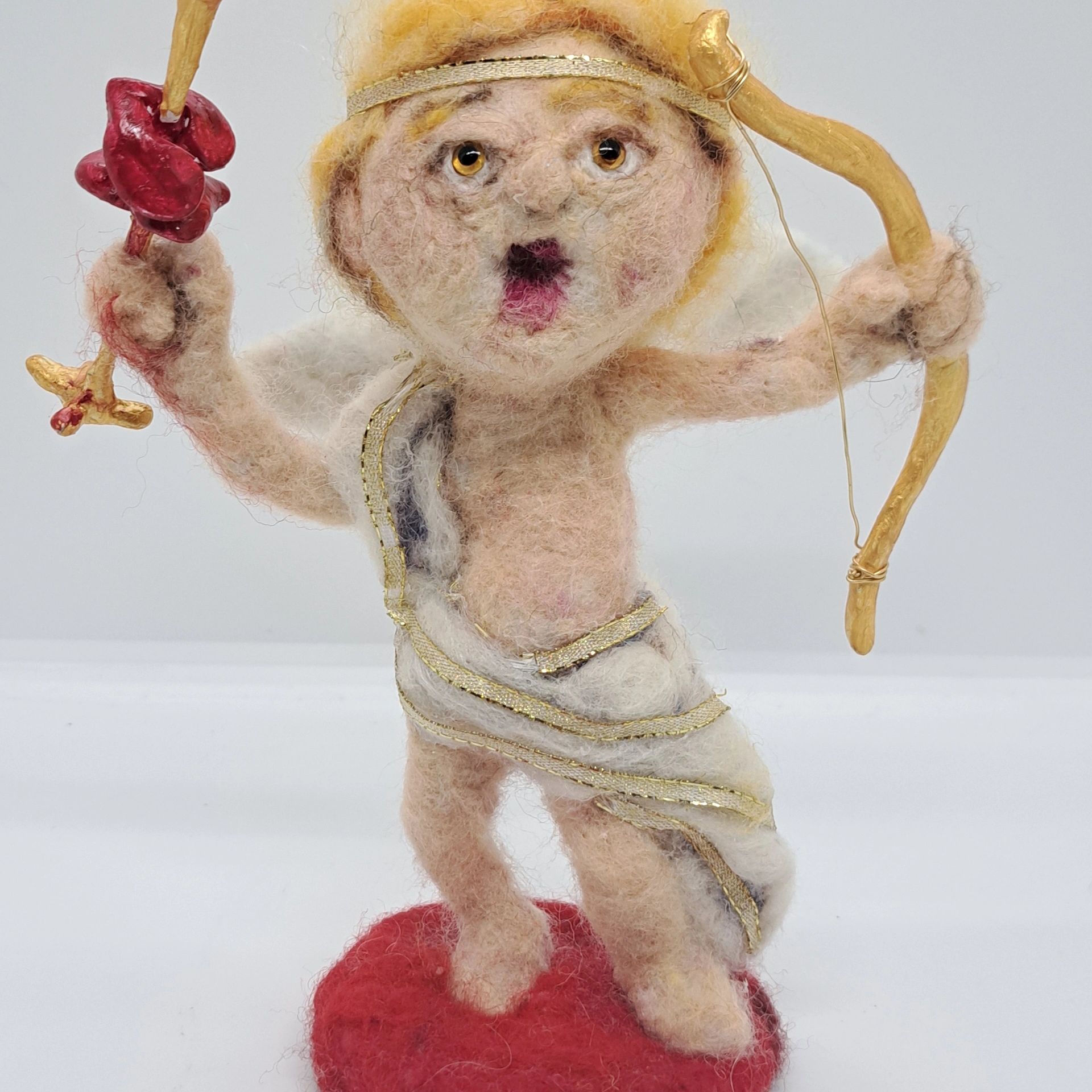 Valentine's Day cherub w/  2 hearts skewered on his arrow.  Needle felt figurine