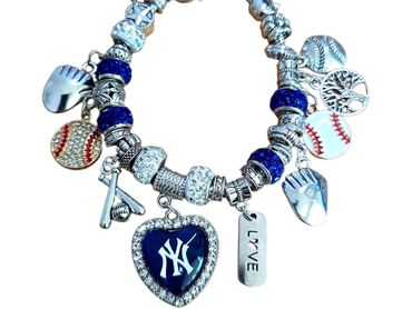 Silver charm bracelet with baseball-themed and NY heart charms.