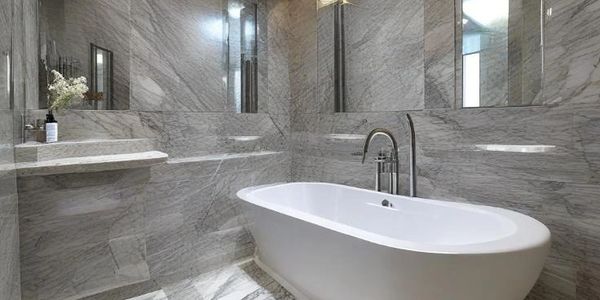 Luxurious grey marble bathroom featuring floor-to-ceiling grey marble tiles.