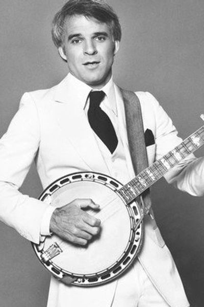 Male playing 5 string banjo