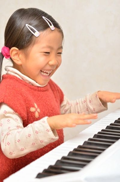 Young Girl learning to play piano at the Norman Music Institute