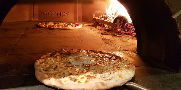 pizza in a stone baked wood fired oven