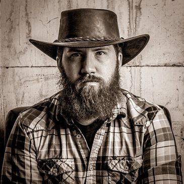 Chris Strei, our artist, in a stylized sepia tone image.