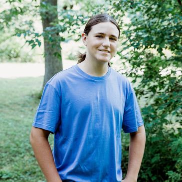 Carter Edwards in front of greenery