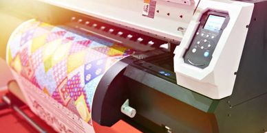 Wide format printer showing printed material in the process of being printed.
