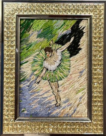Embroidery artwork of a ballerina in a green tutu with dynamic background.