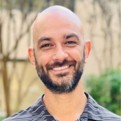 E.J. Costello | StretchVibe - Founder and Owner smiling in a headshot.