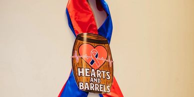 A medal with a heart and barrel design reading 'Hearts and Barrels'.