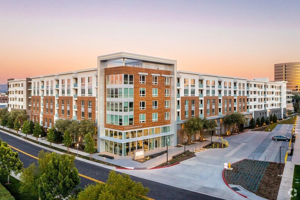 Large modern apartment complex at sunset.