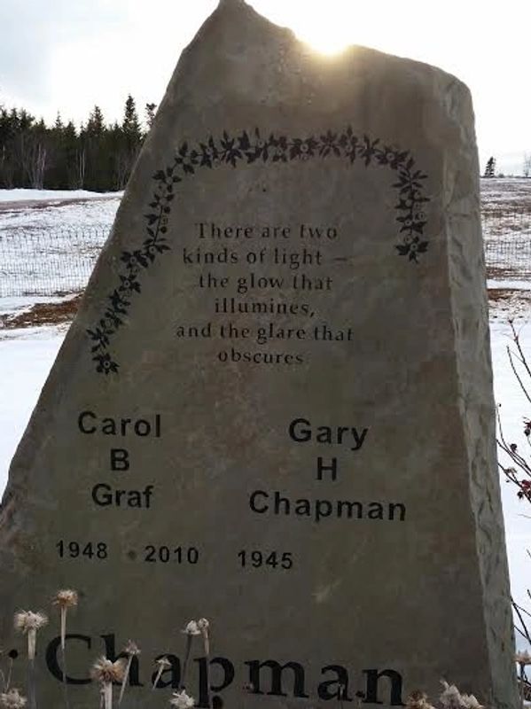 A memorial stone with a thoughtful light-themed quote and two names, Carol B Graf and Gary H Chapman.