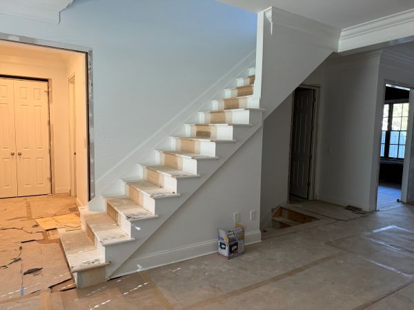 Interior staircase under construction in a house.