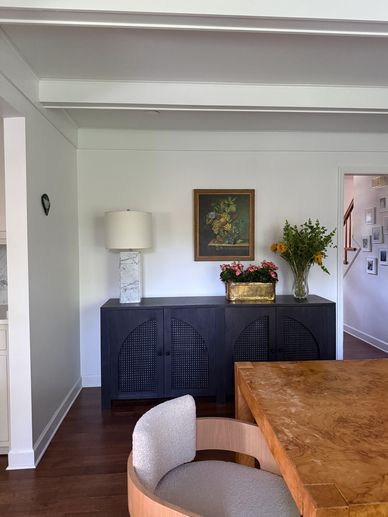 Elegant dining room with wooden table and decor.