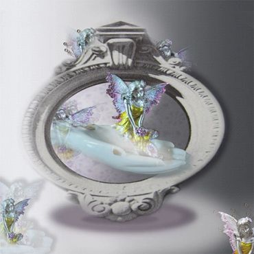 A fantasy-themed mirror with fairy figurines.