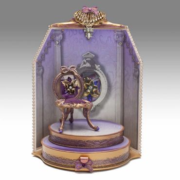 Elegant purple and gold miniature chair display with ornate details.
