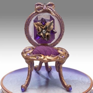 Ornate purple and gold jewelry box shaped like a mini chair.