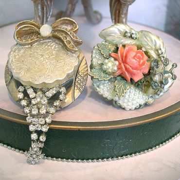 Two vintage decorative boxes with intricate designs and embellishments.