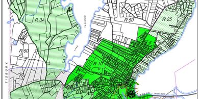 Map showing zoning districts highlighted in green in a city area.