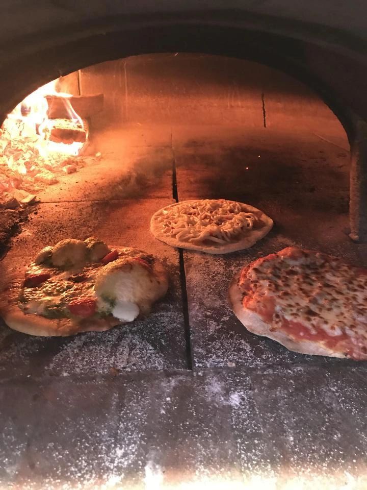 Peace Pizza wood-fired oven setup at an event