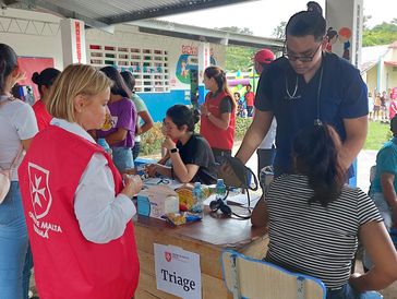 Medical professionals conducting triage at a community health event.