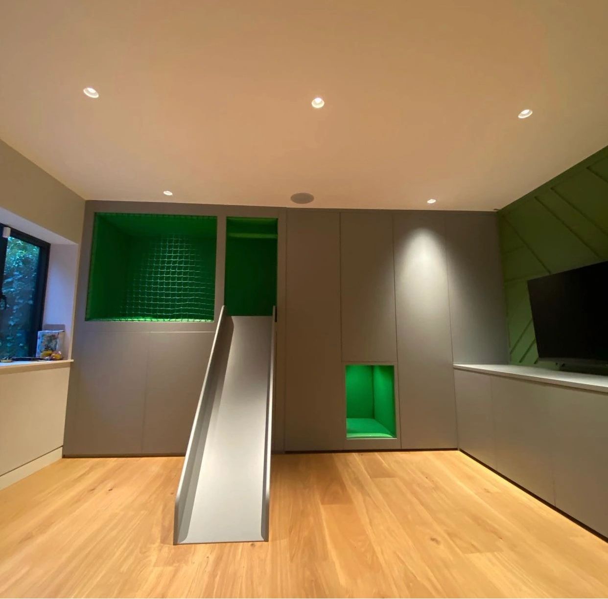 Bespoke playroom home playroom children playroom ideas slide ball pit tv storage tunnel ladder wall 