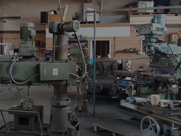 Industrial workshop with heavy machinery and tools.