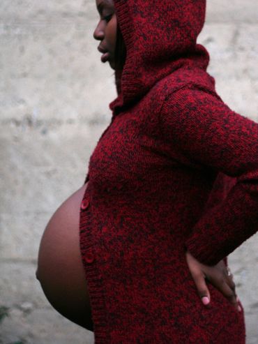 Pregnant woman in red sweater.