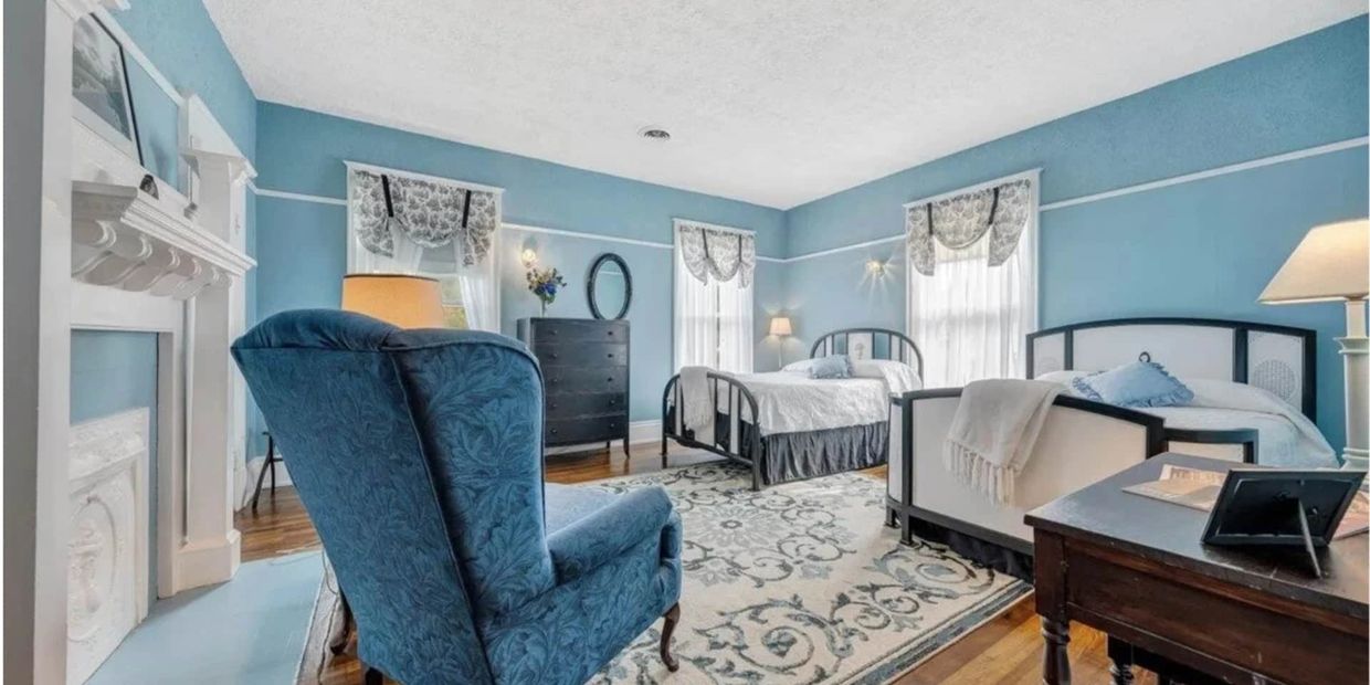 Cozy vintage bedroom with blue walls and twin beds.