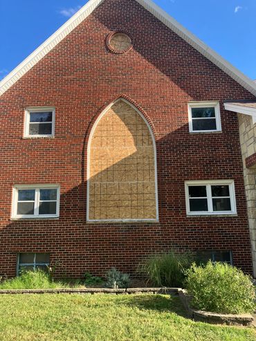 South windows removed for repair. Openings boarded up and sealed.