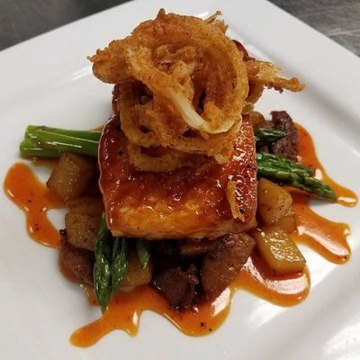 BBQ Glazed Salmon with Andouille Hash, Asparagus, Crispy Onions & a Spicy Gastrique Sauce.