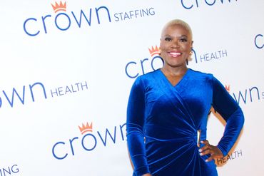 Woman in blue dress at event.