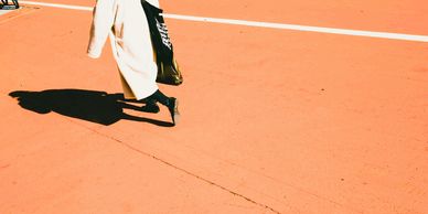 a figure walking away on an orange outdoor ground Arcadia Search executive search and pr recruitment