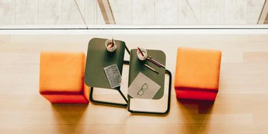 two orange stools and two drinks ready for a meeting or a job interview Arcadia Search PR interview