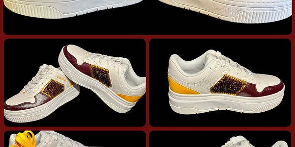 White sneakers with maroon, yellow, and studded design.