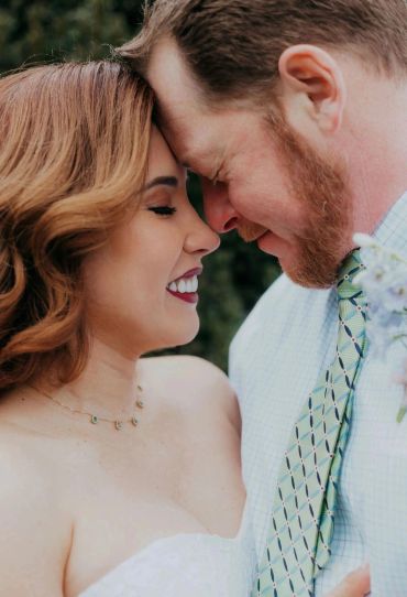 Couple sharing a loving moment with foreheads touching.