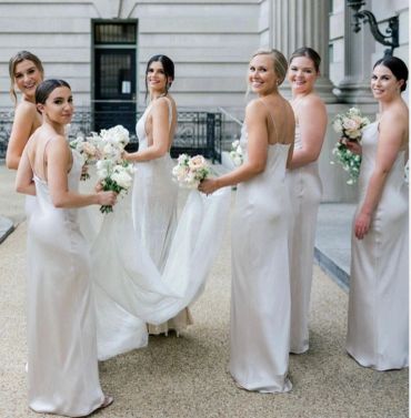 Bridesmaids and bride in elegant white dresses.
