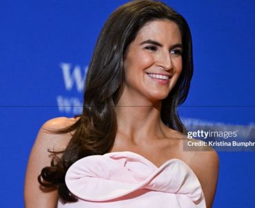 Woman smiling in a pink dress.